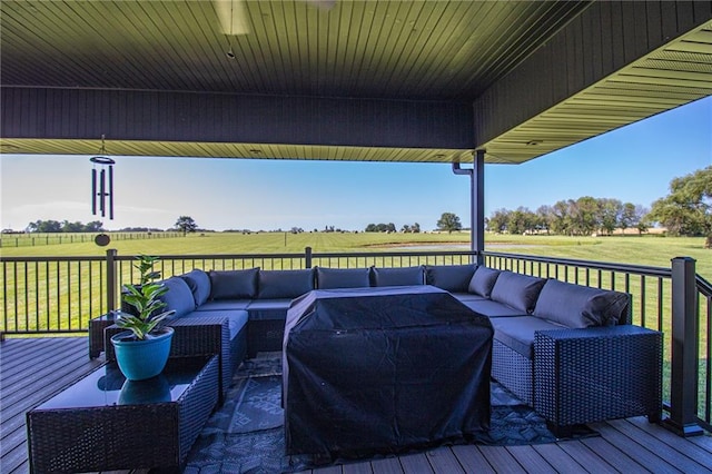 wooden deck with an outdoor hangout area and a lawn