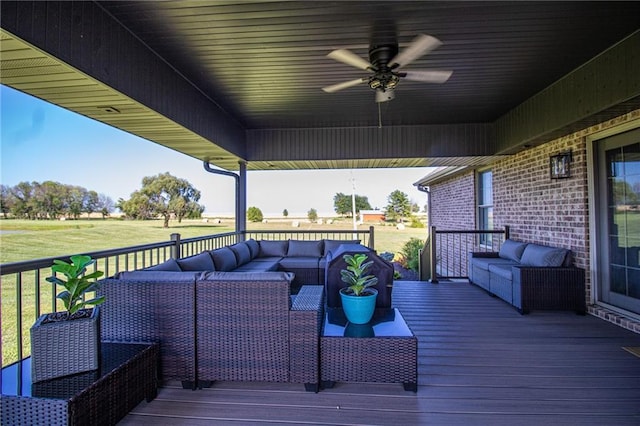 deck with a lawn, an outdoor living space, and ceiling fan