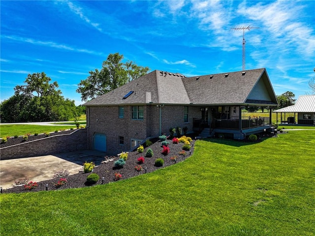 rear view of house featuring a yard