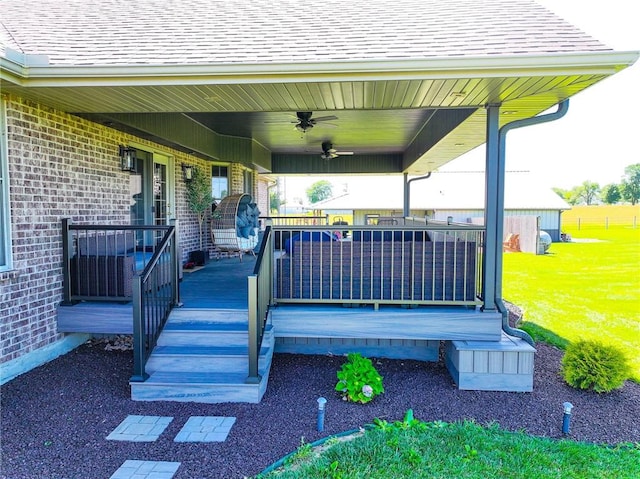 exterior space featuring a lawn, ceiling fan, and a porch