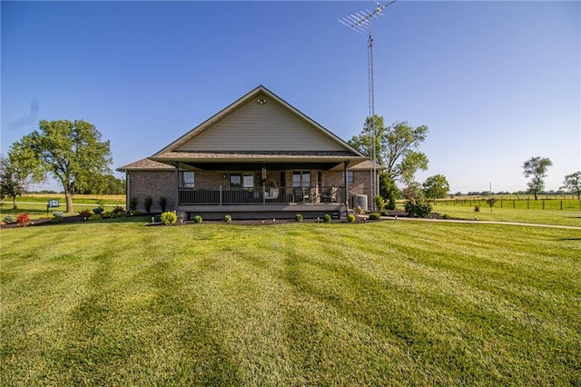 rear view of property with a yard