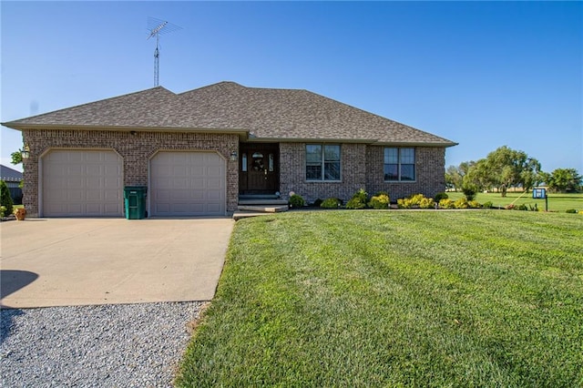 view of front of home featuring a front lawn and a garage