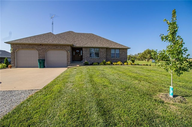 view of front of property featuring a garage and a front yard