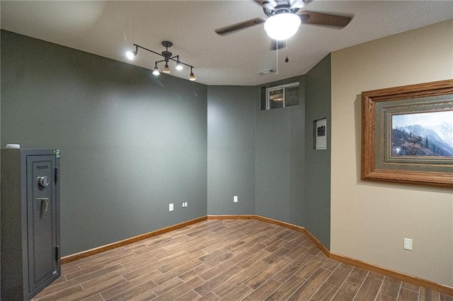 unfurnished room featuring ceiling fan and hardwood / wood-style flooring