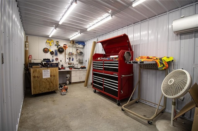 garage with a workshop area and an AC wall unit