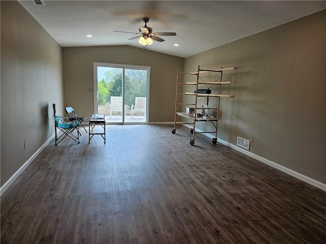 interior space featuring vaulted ceiling, dark wood-type flooring, and ceiling fan