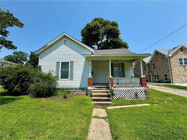 bungalow-style house with covered porch and a front yard