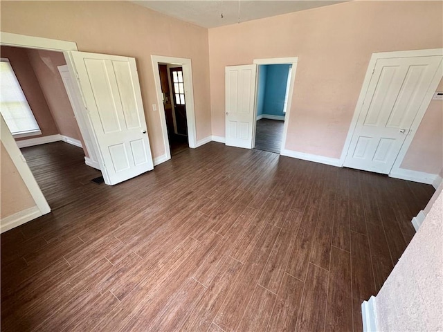 unfurnished bedroom featuring dark hardwood / wood-style floors