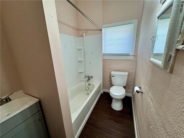 full bathroom featuring  shower combination, hardwood / wood-style floors, vanity, and toilet