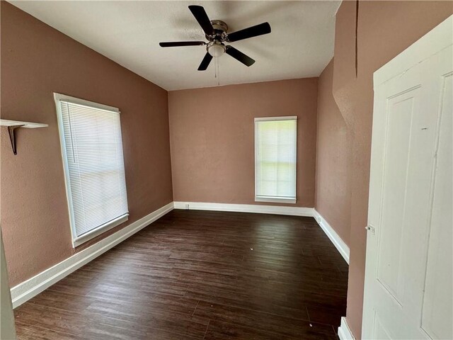 spare room featuring ceiling fan and dark hardwood / wood-style flooring