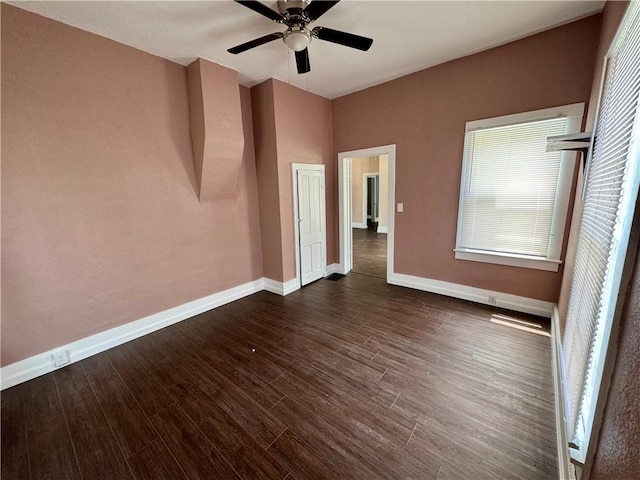 spare room featuring dark wood-type flooring and ceiling fan