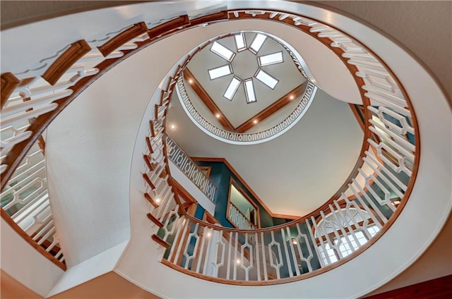 staircase featuring a high ceiling