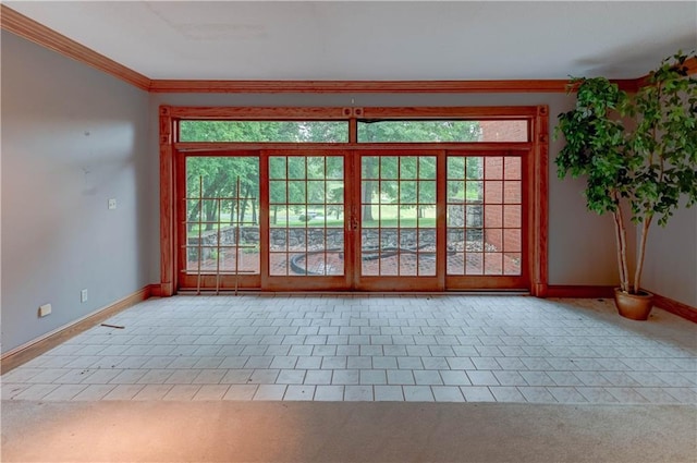 doorway featuring crown molding and light colored carpet