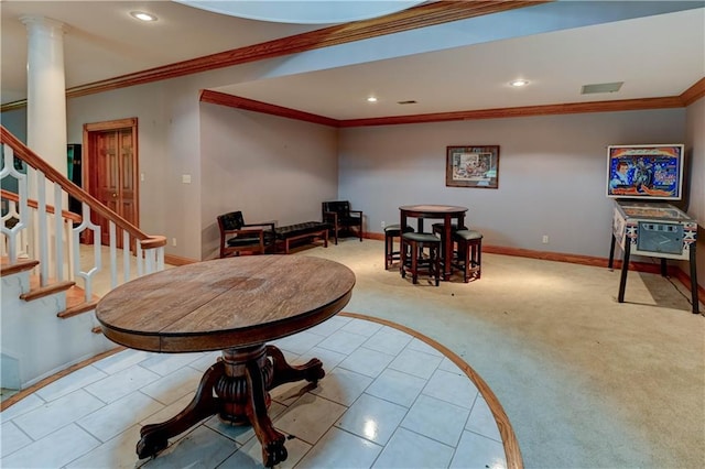 dining space with ornamental molding, light carpet, and decorative columns