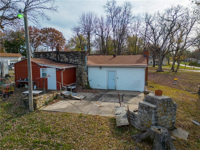 back of property with a patio and a shed