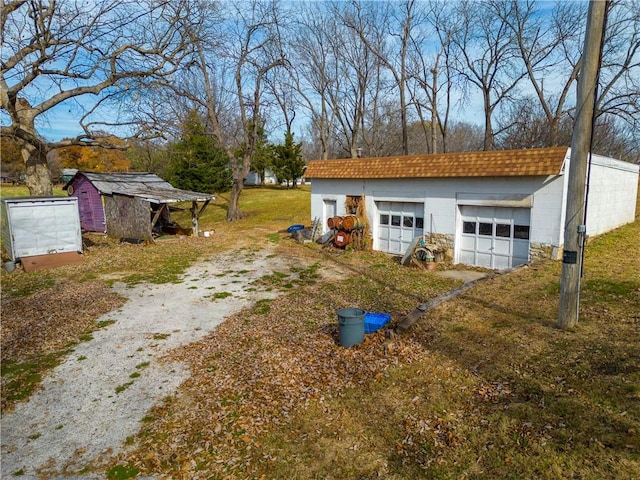 exterior space with a garage and an outdoor structure