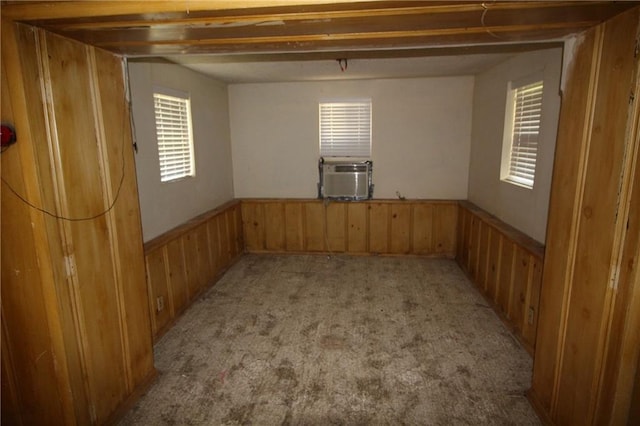 empty room featuring cooling unit and light colored carpet