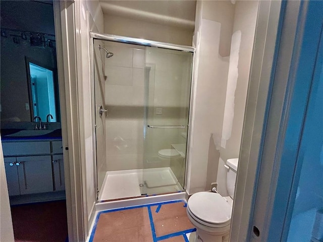 bathroom featuring vanity, toilet, and walk in shower