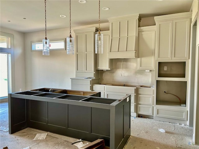 kitchen with decorative backsplash, pendant lighting, a center island, and cream cabinetry