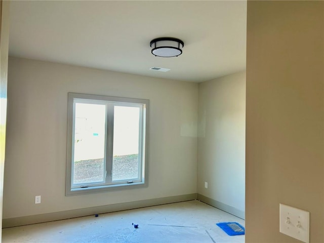 empty room featuring visible vents and baseboards