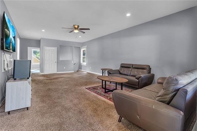 living room with ceiling fan, carpet floors, and a wealth of natural light