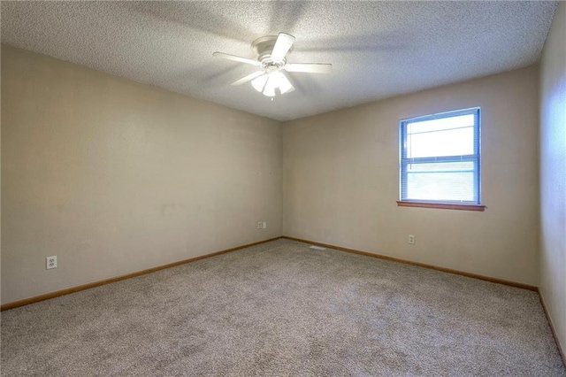 carpeted spare room with ceiling fan and a textured ceiling