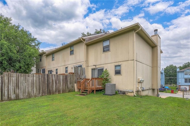 back of house featuring a yard, cooling unit, and a deck