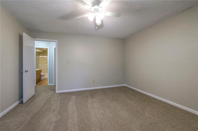 unfurnished room with ceiling fan, a textured ceiling, and carpet