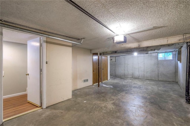 basement featuring a textured ceiling