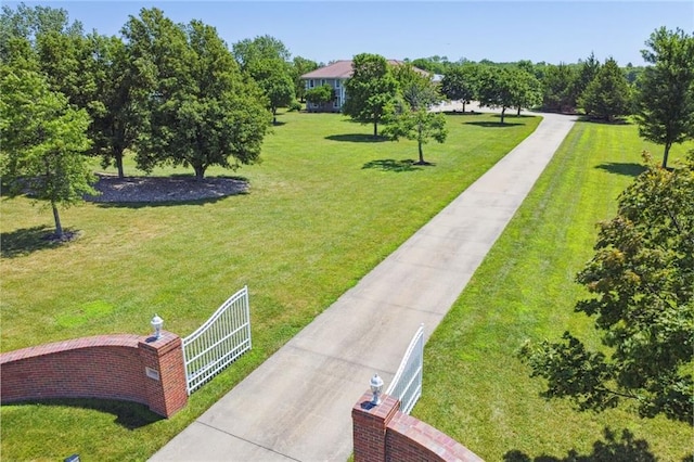 view of home's community featuring a yard and fence