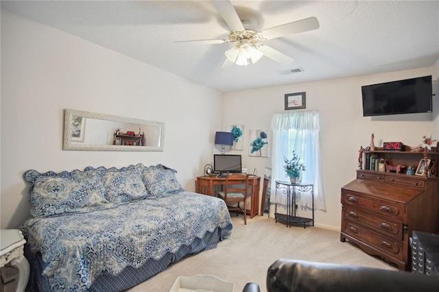 bedroom featuring light carpet and ceiling fan