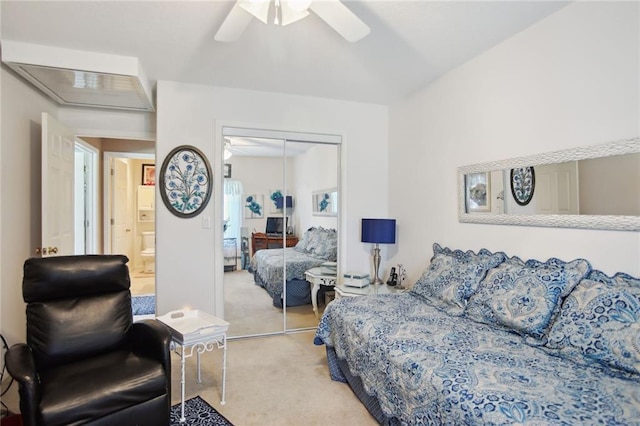 carpeted bedroom featuring ceiling fan and a closet