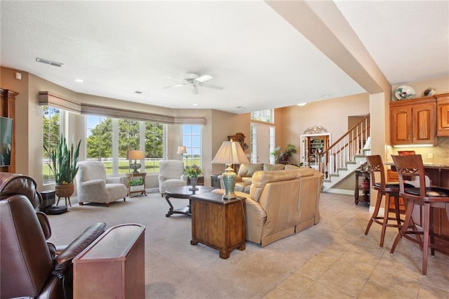 living room featuring ceiling fan and light tile patterned flooring