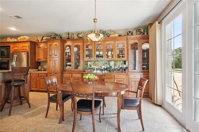 dining room featuring light tile patterned flooring and visible vents