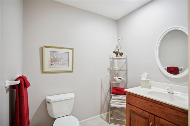 bathroom featuring tile patterned flooring, vanity, and toilet