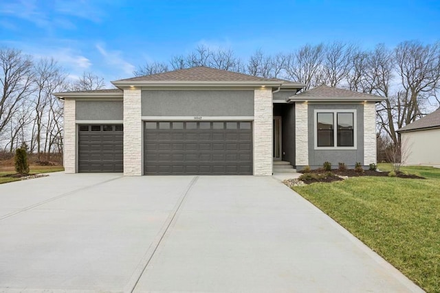 prairie-style house featuring a garage and a front yard