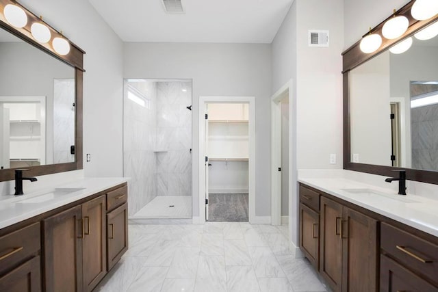 bathroom with vanity and tiled shower