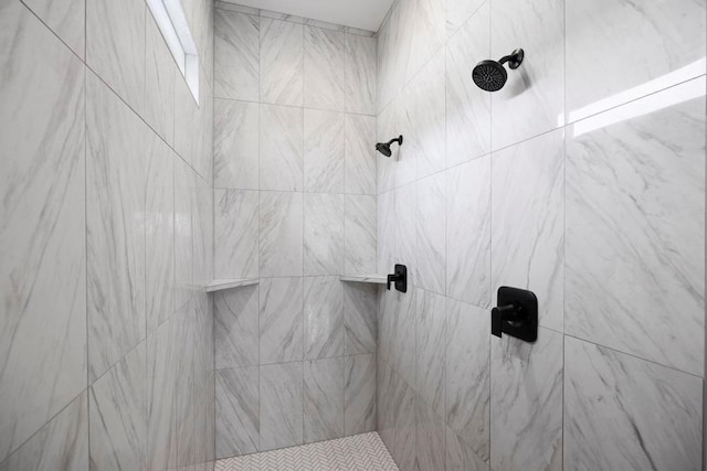 bathroom with tiled shower