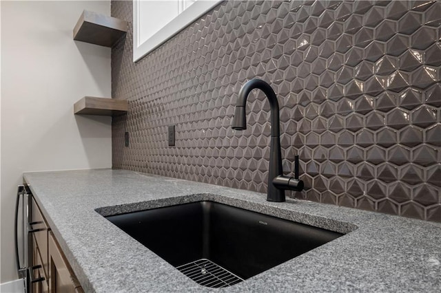 room details featuring sink and tasteful backsplash