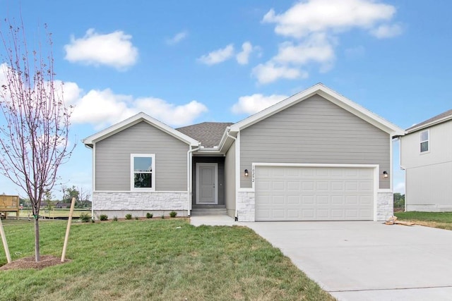 view of front facade with a front yard and a garage