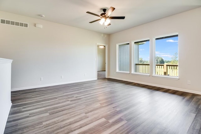 spare room with ceiling fan and dark wood-type flooring