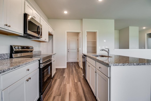 kitchen featuring stone countertops, white cabinetry, sink, and appliances with stainless steel finishes