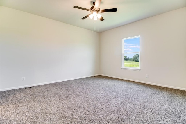 spare room with carpet floors and ceiling fan