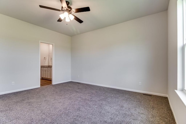 unfurnished room featuring dark carpet and ceiling fan