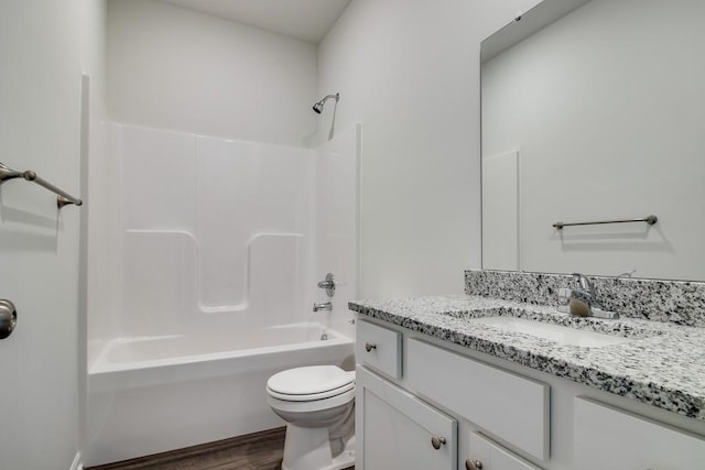 full bathroom with hardwood / wood-style floors, vanity, toilet, and bathtub / shower combination