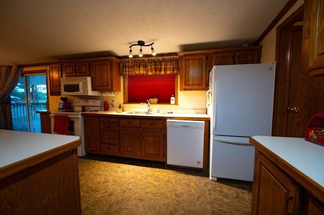 kitchen featuring sink and white appliances