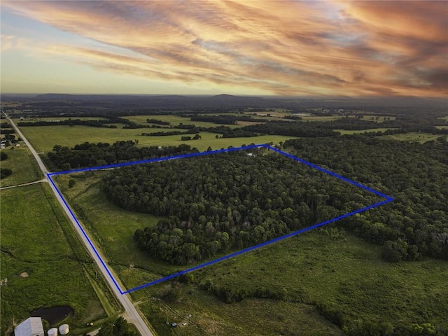 aerial view at dusk featuring a rural view