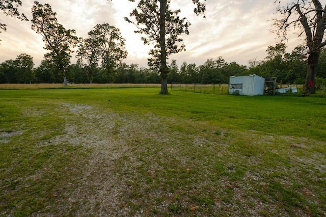 view of yard at dusk