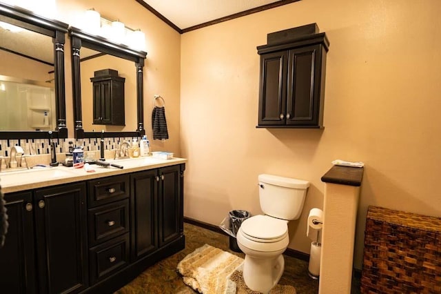 bathroom with toilet, vanity, crown molding, and tasteful backsplash