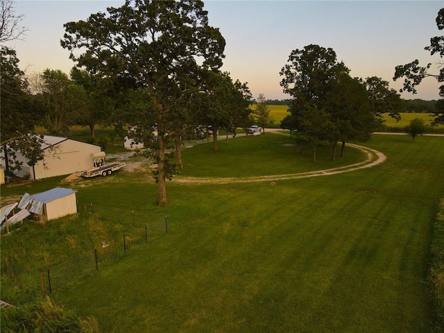 view of community with an outbuilding, a rural view, and a lawn